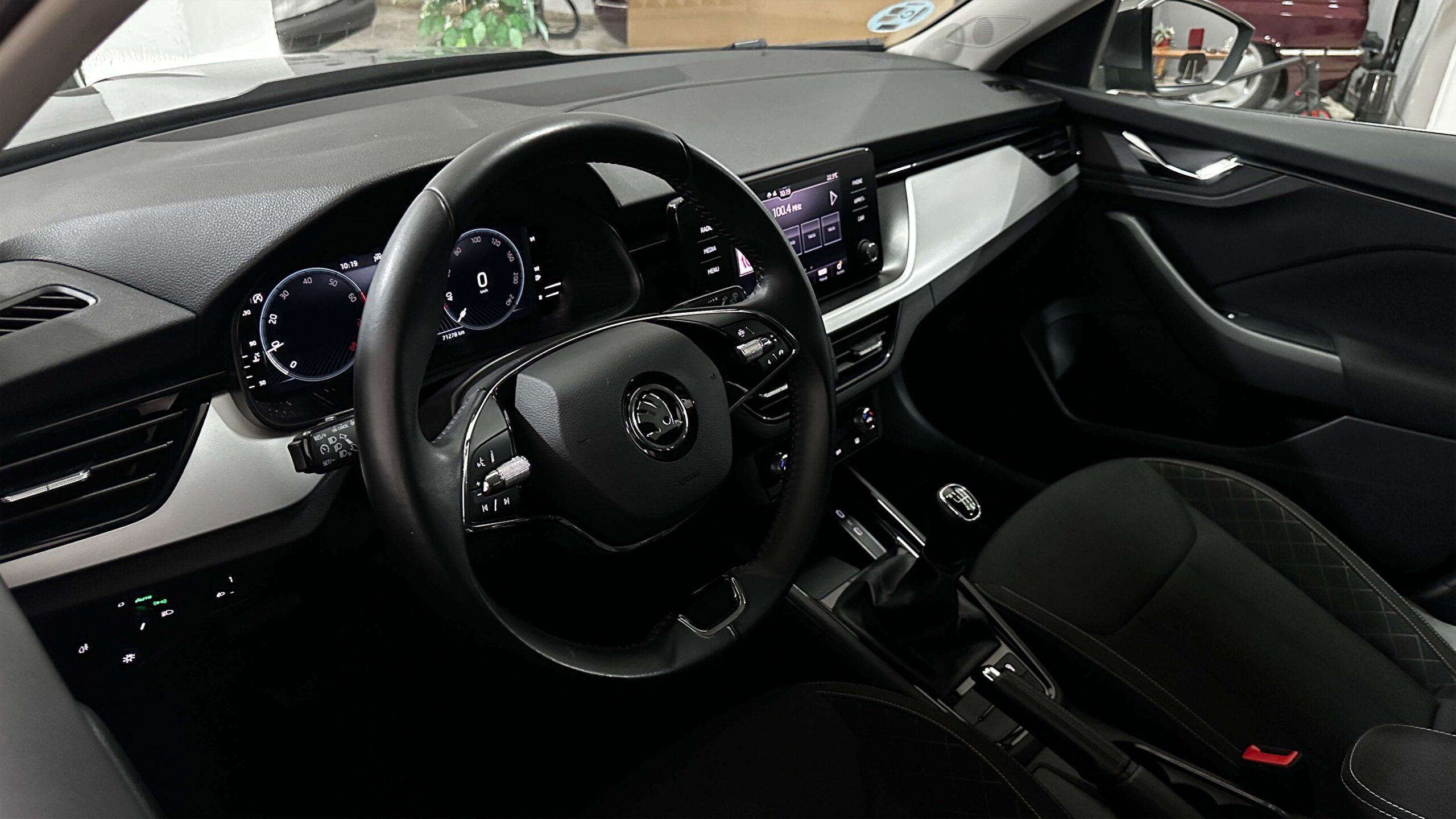 The headlights and the hood of a black luxury car