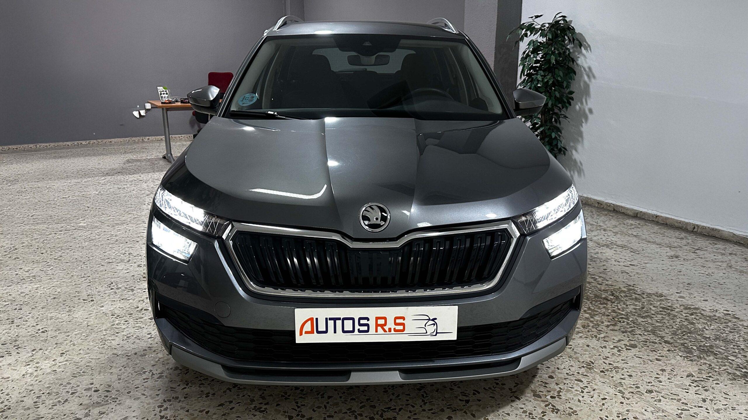 The headlights and the hood of a black luxury car